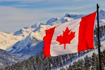 Canadian flag with mountains in the background